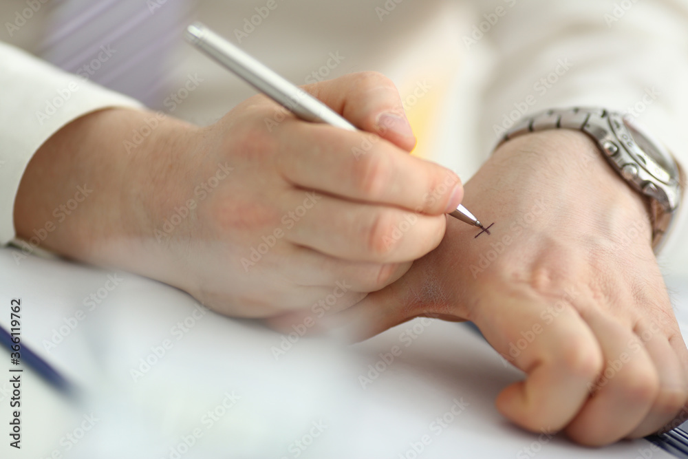 Top view close up of office male hands while he is writing cross for not forgetting something important