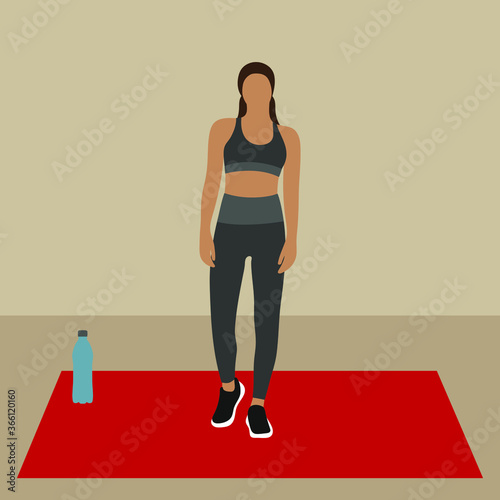 Young woman on fitness mat and bottle of water