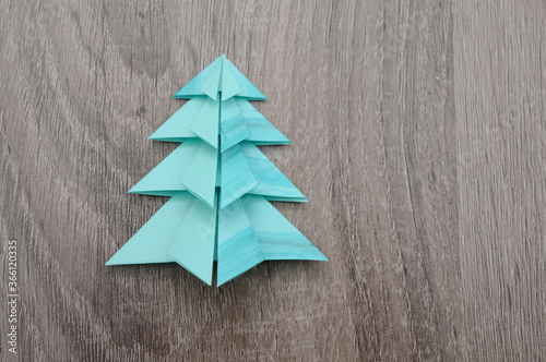 Origami Christmas tree paper wooden background