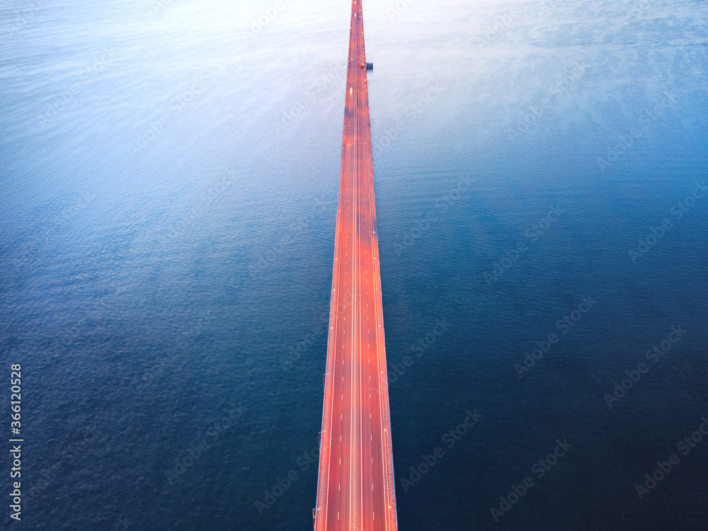 Endless illuminated bridge over dark water