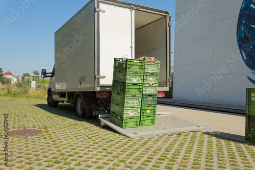 Unloading food crates. Delivery of goods to shops and cafes