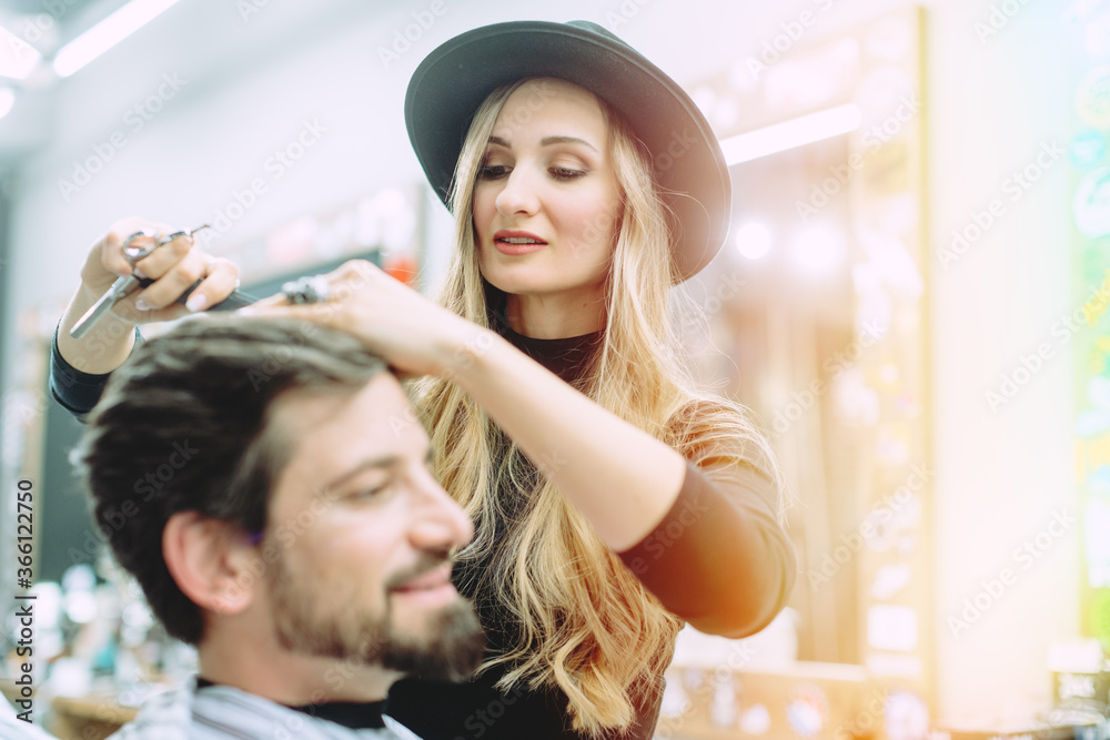 Fototapeta premium Hair stylist trying to get her client a proper cut