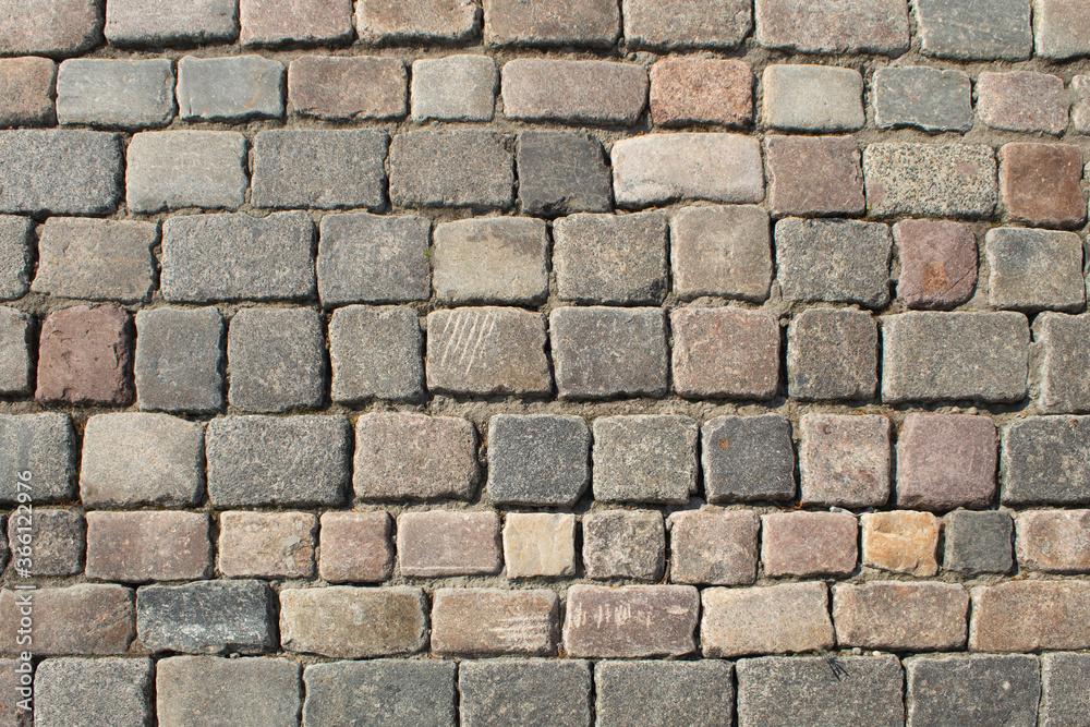 The road is lined with round cobblestones The road is lined with round cobblestones