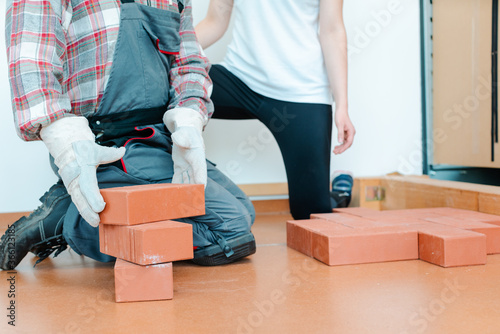 Worker in occupational therapy re-learning to lay bricks