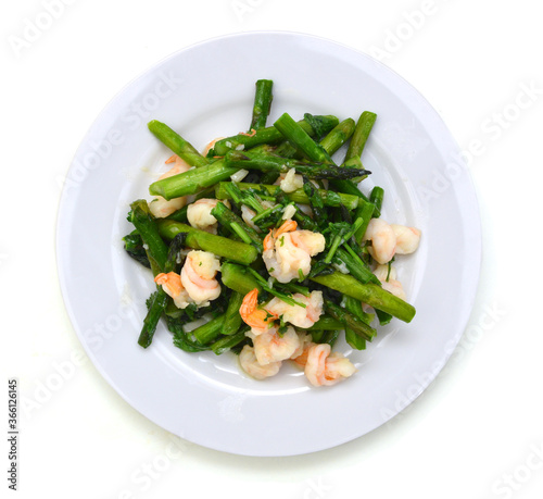 Fried shrimp with asparagus in plate on white