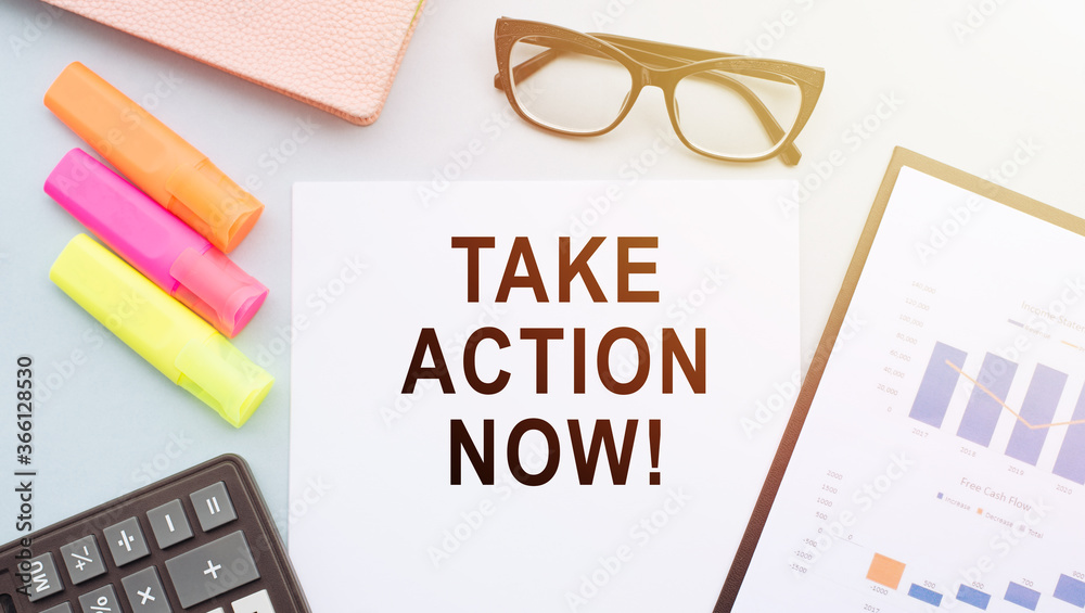 Take action Now words on notebook closeup on office table Take action Now words on notebook closeup on office table