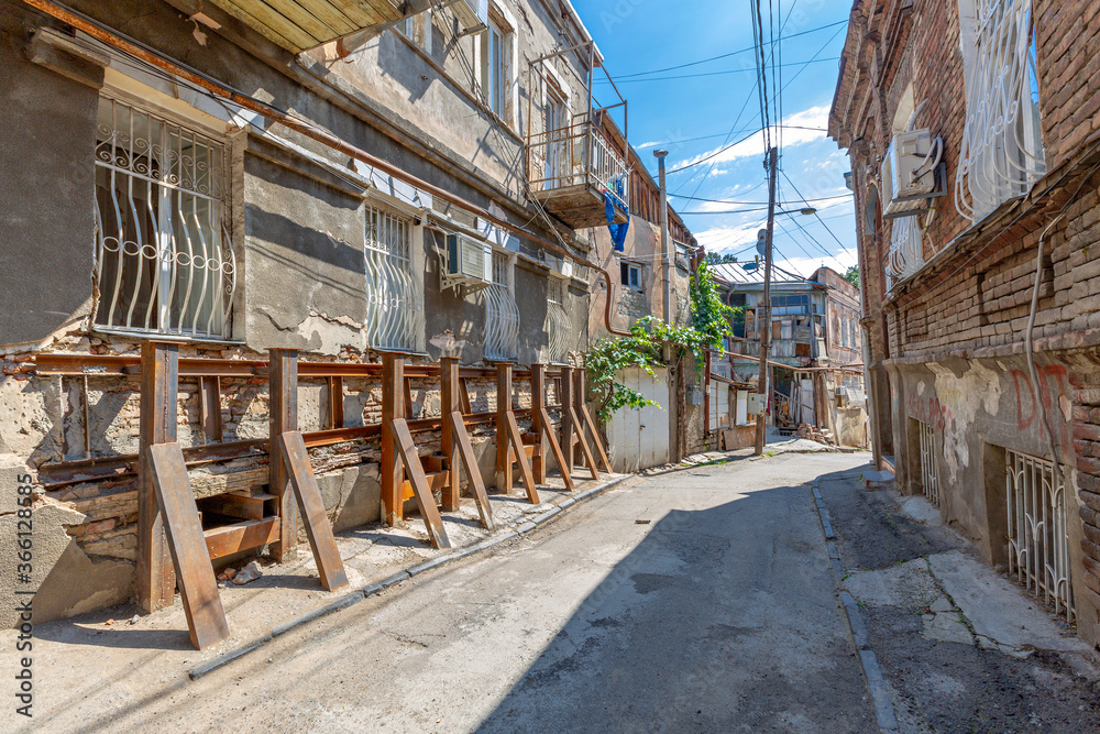 Old houses held with steel bars for restoration in the old part of Tbilisi, Georgia