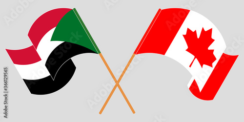 Crossed and waving flags of Sudan and Canada