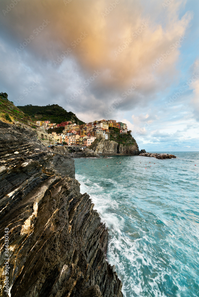 Waves crashing on cliffs at sunset, Manarola, Cinque Terre, La Spezia province, Liguria Waves crashing on cliffs at sunset, Manarola, Cinque Terre, La Spezia province, Liguria
