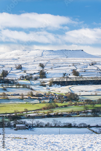 Fresh snow and winter sunshine covering the fell tops in Wensleydale around Nappa Scar and Addlebrough, North Yorkshire photo