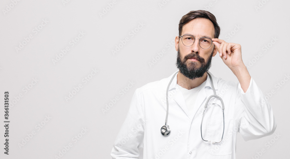 young male doctor in uniform holding glasses with stethoscope. medical concept young male doctor in uniform holding glasses with stethoscope. medical concept