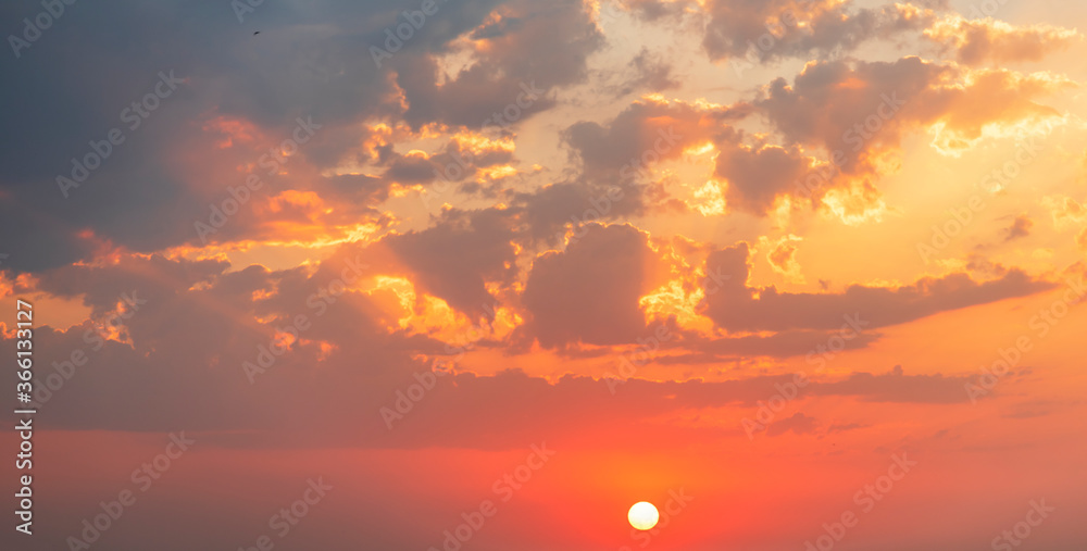 Fototapeta premium Beautiful colorful sunset sky with orange clouds. Nature sky background.