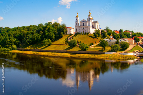 Vitebsk,Belarus - 18 July 2020 : Holy Assumption Cathedral of the Assumption on the hill and the Holy Spirit convent and Western Dvina River. Vitebsk, Belarus photo