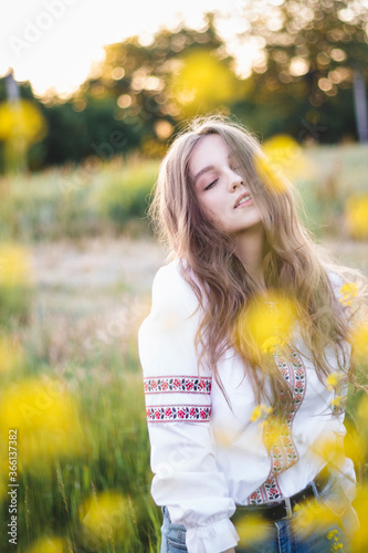 portrait of a woman in a field with yellow flowers