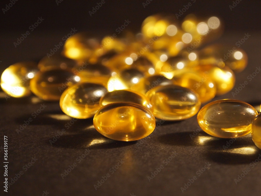Trans-lucid cod liver oil pills under colourful light Trans-lucid cod liver oil pills under colourful light
