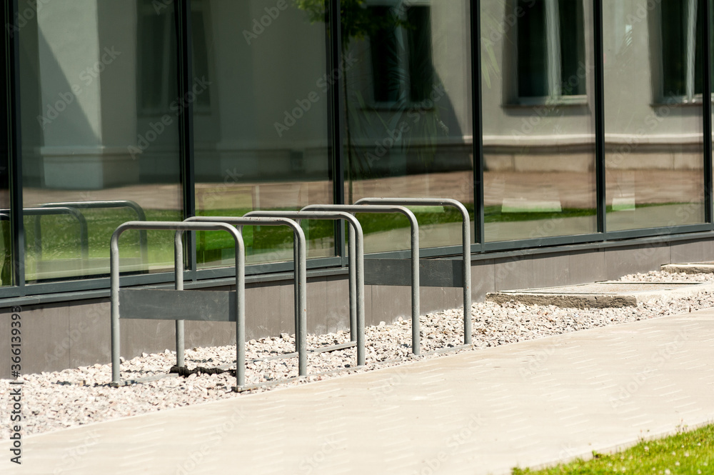 Bicycle park for office workers. Metal handrail bicycle parking near the office Bicycle park for office workers. Metal handrail bicycle parking near the office