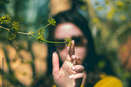 No face portrait where girl touch a tree branch, around the nature , the touch represent the connection between the nature and humanity. photo