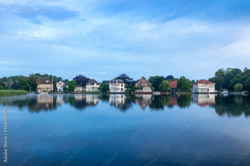 A row of beautiful villas on the Warmonderleede with a view of the island of Koudenhoorn in the South-Holland village of Warmond in the Netherlands