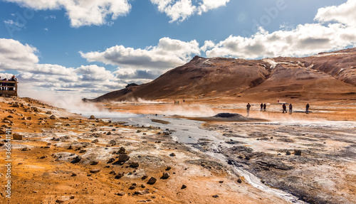 Tipical Icelandic nature landscape. Hverarondor Hverir geothermal area in Iceland near Lake Myvatn. Boiling Mudpot in the geothermal area Hverir, Iceland. The area with multicolored mud and steam.
