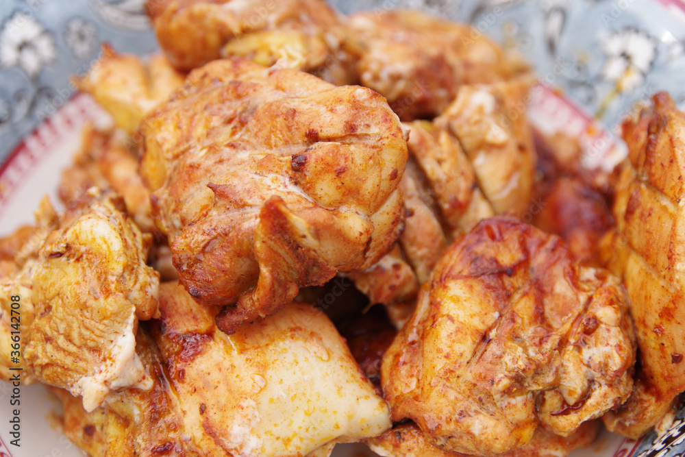 Chicken shashlik. Shashlik or Shish kebab popular in Eastern Europe. Marinated shashlik preparing on a barbecue grill over charcoal. Chicken hip barbecue. Fried meat in plate. Chicken shashlik. Shashlik or Shish kebab popular in Eastern Europe. Marinated shashlik preparing on a barbecue grill over charcoal. Chicken hip barbecue. Fried meat in plate.