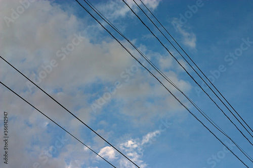 wires against a cloudy summer sky