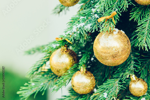 Green fir tree with golden balls. Christmas wallpaper.