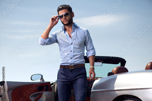 Handsome man near the car. Luxury life. © ASjack