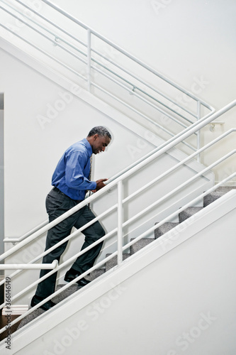 Wallpaper Mural Black businessman climbing staircase Torontodigital.ca