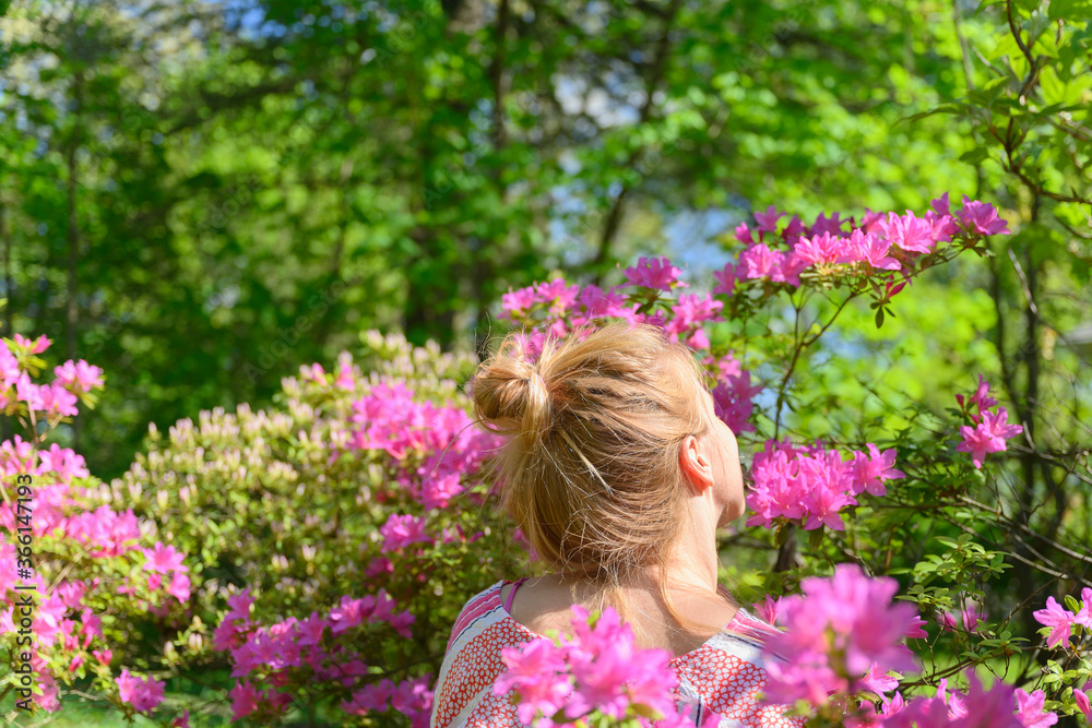 Woman smelling pink flowers