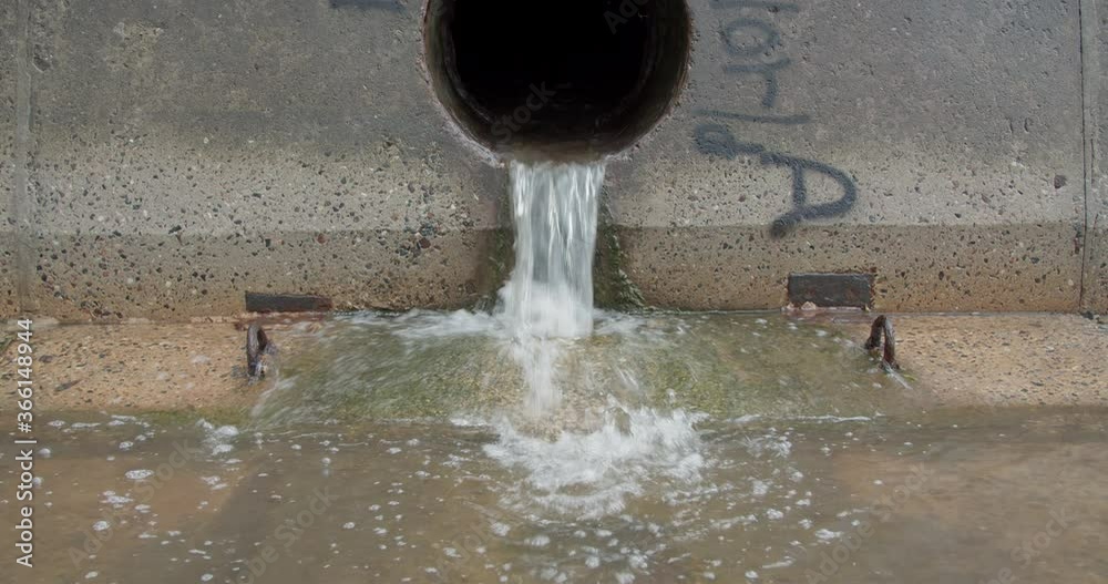 Water pollution from sewer pipe wastewater flowing into sea Water pollution from sewer pipe wastewater flowing into sea