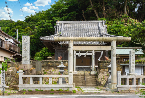 Torii gate of the shintoist Kanaya Shrine dedicated to the god of metal Kanayama Hikonokami at the foot of the stone quarry of Mount Nokogiri or sawtoothed mountain. photo