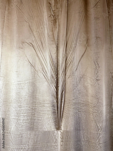 The folds of the fabric are light brown. Closeup background texture