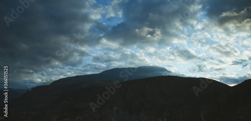 sunrise in the andes mountains with the sky covered with clouds