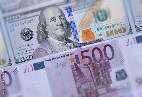 US american 100 dollars bills, European Union currency 500 euro banknotes closeup money background. USA Europe economies relations, business market, trading, payments, financial crisis concept image