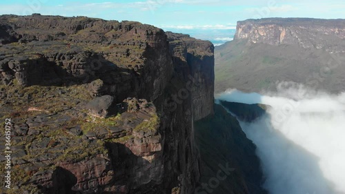 The Rocky Mountain Landscape Of Mount Roraima With Low Lying Clouds On A Sunny Day In Venezuela. Plateaus In South America.  - aerial drone photo