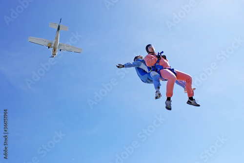 Sky dive tandem jump with blue background