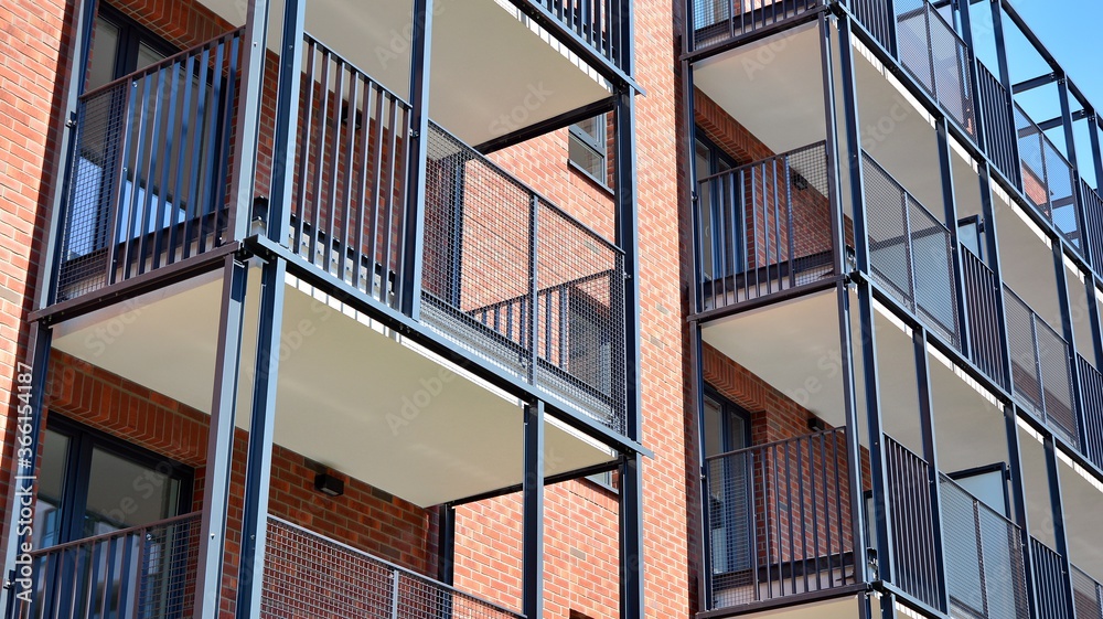 Modern apartment buildings on a sunny day with a blue sky. Facade of a modern apartment building. Glass surface with sunlight. Modern apartment buildings on a sunny day with a blue sky. Facade of a modern apartment building. Glass surface with sunlight.