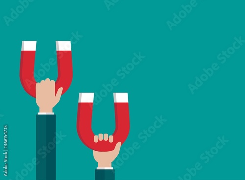 Hands with red horseshoe magnets. Businessman attracting money, customers, investment success.