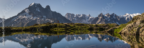 hiker in mountains with reflection in lake © Francois DAVID