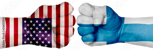 Fototapeta Naklejka Na Ścianę i Meble -  Two hands are clenched into fists and are located opposite each other. Hands painted in the colors of the flags of the countries. Finland vs USA