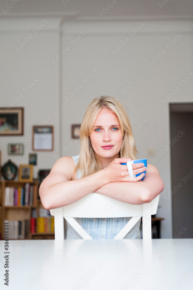 Portrait of smiling blond woman leaning on back rest Portrait of smiling blond woman leaning on back rest