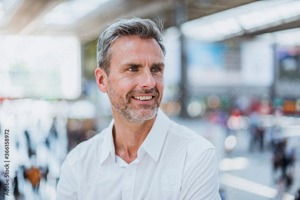 Close-up of thoughtful businessman looking away while standing in city