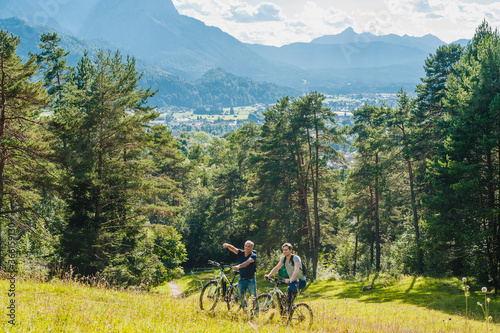 Senior and mature man with e-bikes