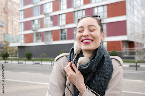 Close-up of smiling woman with white rats on scarf standing against building photo