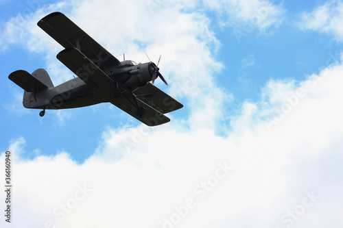 Classic old retro vintage airplane with a propeller in the sky on a background of clouds photo