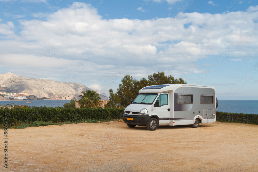 Travel trailer camper van parked at a beautiful camping with seaside and mountains landscape views. Travel trailer camper van parked at a beautiful camping with seaside and mountains landscape views.