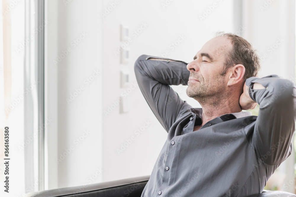Portrait of mature man with eyes closed relaxing with hands behinds his head Portrait of mature man with eyes closed relaxing with hands behinds his head