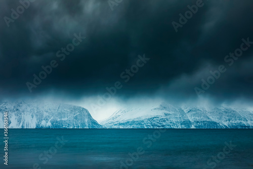 Cloudy atmosphere at the coast in winter, Fjord Lyngen, Skibotn, Norway photo