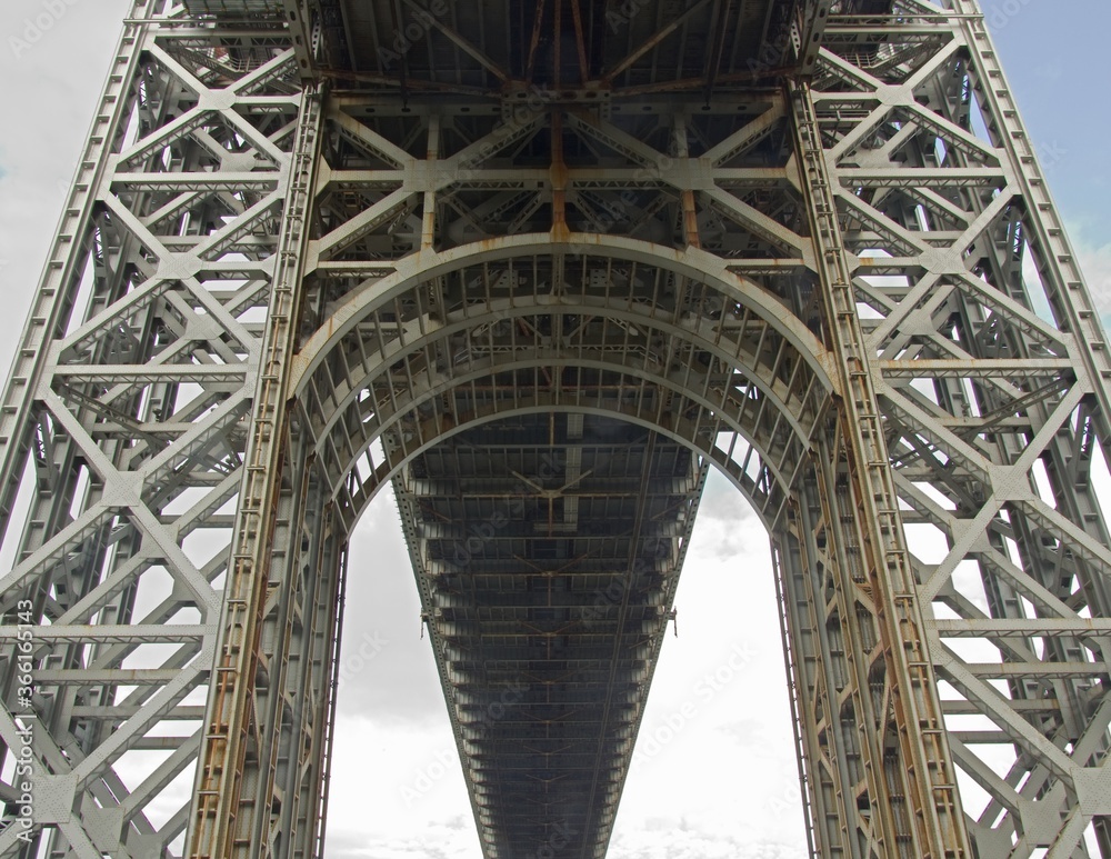 Fort Lee, NJ / United States - May 14, 2020: Vertical closeup of underneath the historic George Washington Bridge. The bridge is a double-decked suspension bridge spanning the Hudson River