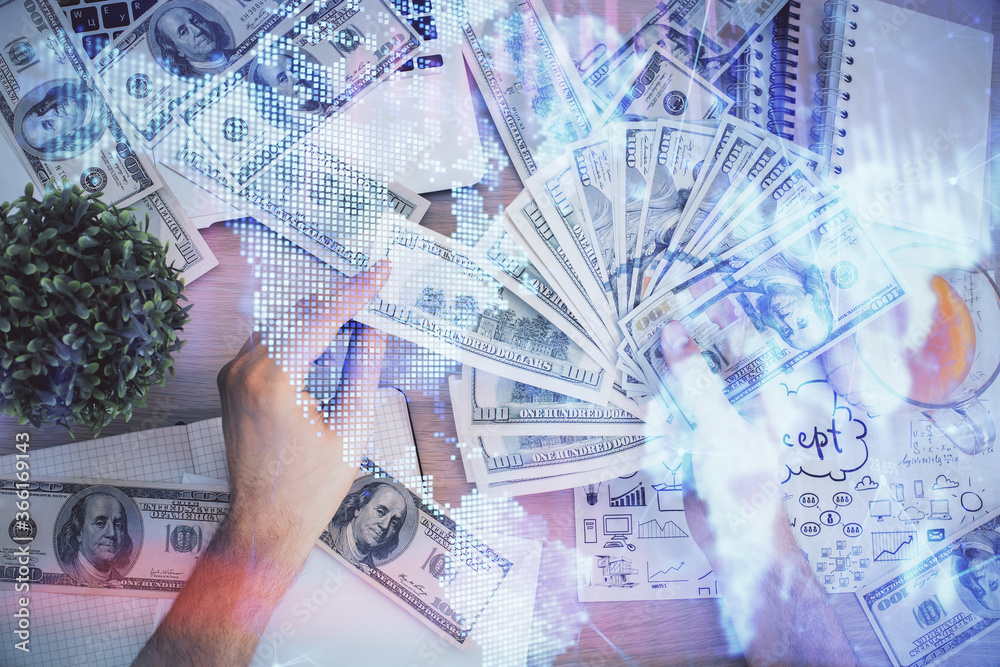 Multi exposure of financial graph drawing hologram and USA dollars bills and man hands. Analysis concept. Multi exposure of financial graph drawing hologram and USA dollars bills and man hands. Analysis concept.